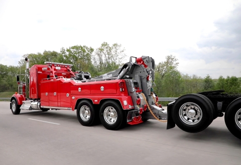 Image of a Vulcan V70 heavy-duty wrecker towing a tractor trailer down the highway.