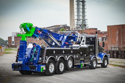 black and blue vulcan 975 rotator in the parking lot of a factory