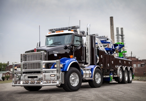 front of a black and blue vulcan 975 rotator on a kenworth w900 chassis
