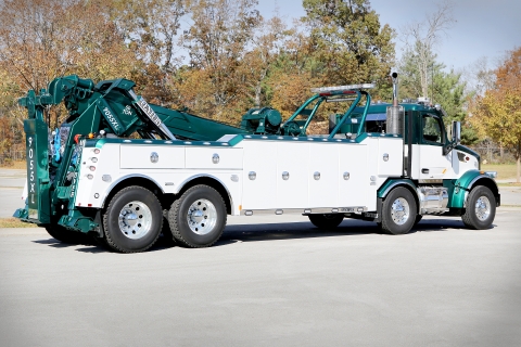 White and green Century 9055XL on a Peterbilt 567 tandem tandem chassis.