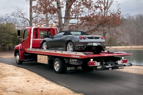red chevron 12 series lcg with loadrite option loaded up with a gray ferrari convertible