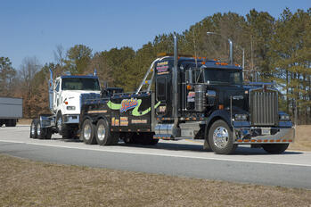 Century 5130 towing a road tractor through the highway scales.