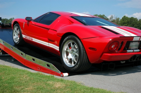 red ford gt being loaded on a red century 12 series lcg carrier with right approach option