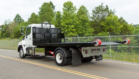 white titan c series roll off unit on a hino 258 chassis