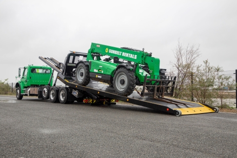 titan zla on green Freightliner m2 chassis bed at angle loaded with equipment