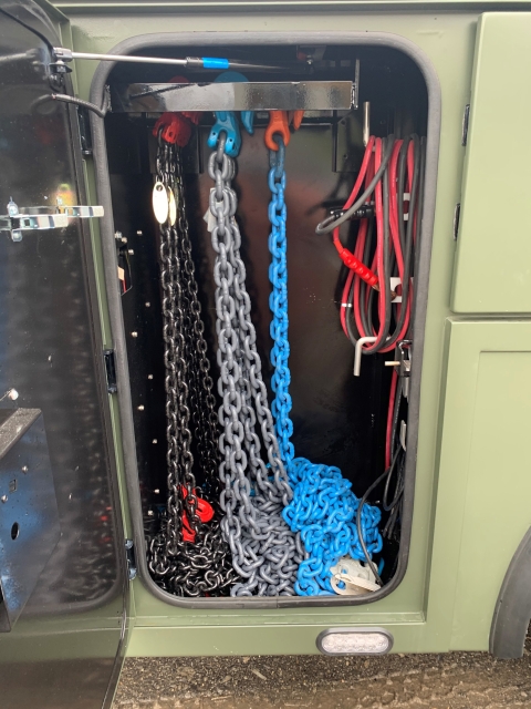 Image inside the 9055 tool box showing the heavy-duty chain rack for storage and organization of towing and recovery chains.