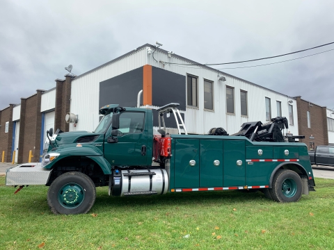 Side view of a Century 4024 heavy-duty wrecker in army green