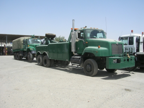 Century 5230 towing an army personnel carrier truck.
