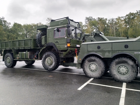 Front view of a Century 5230 towing a military cargo truck