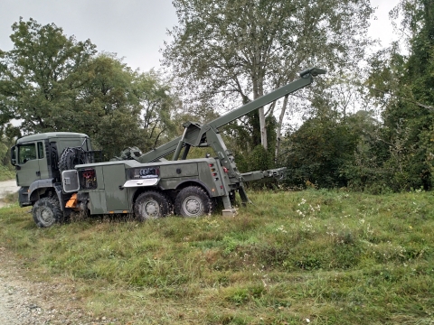 Rear view of a Century 5230 winching a disabled military vehicle.