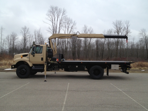 Side view of a Century LD Military carrier with the recovery arm extended to the rear