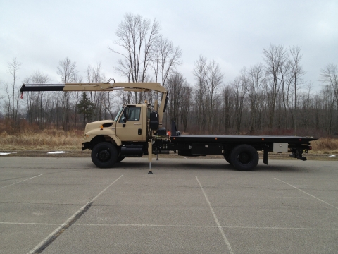 Side view of a military carrier with the recovery arm extended to the front