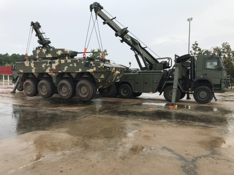 Two military Century 1140 rotators lifting an armored combat vehicle