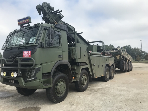 Image showing a military Century 140 rotator towing a military armored combat vehicle.