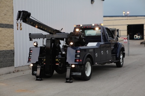 Image show the low reach of the recovery boom off of the tailboard of the wrecker.