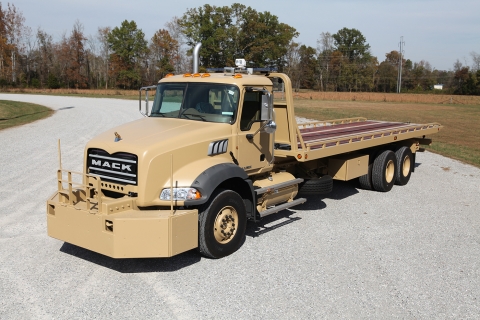 Front view of a Century heavy-duty military carrier in desert tan.