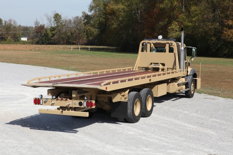 Rear view of a Century heavy-duty military carrier in dessert tan.