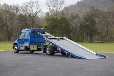 12 series lcg right approach car carrier on a blue freightliner m2 with bed back