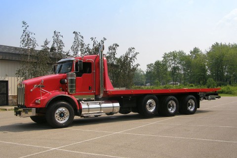 red kenworth w900 chassis with a century 40 series carrier