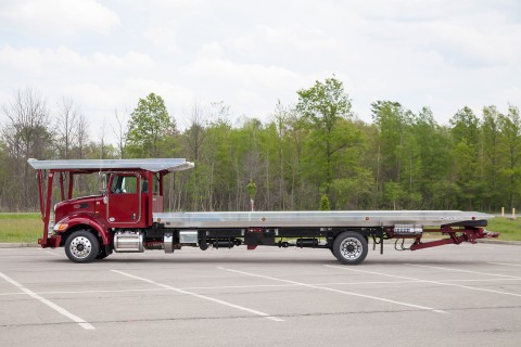 Chevron 4 car carrier on a red peterbilt chassis