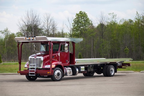 Chevron 4 car carrier on a dark red peterbilt chassis