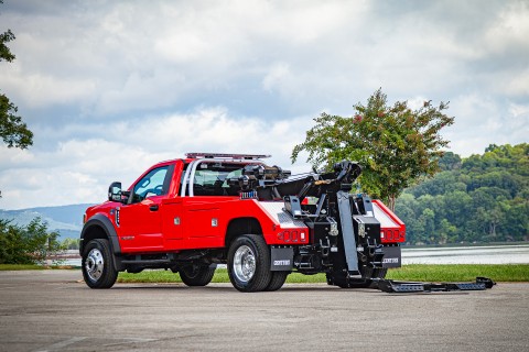 red ford f600 with a century 2465 wrecker underlift folded down and extended