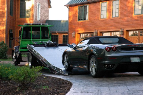 loading a grey ferrari onto a vulcan 12 series lcg carrier with extreme angle option