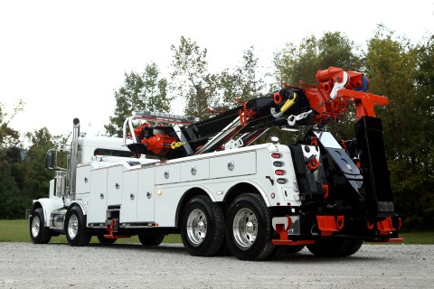 white orange and black vulcan 950 rotator on a peterbilt 389 chassis