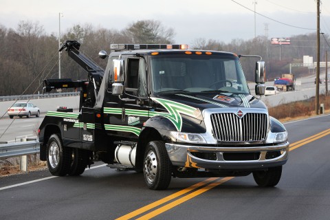 black vulcan v24 on an international mv chassis working a roadside recovery